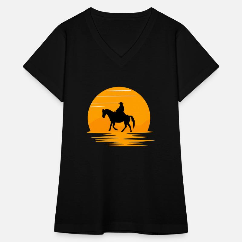 A cowboy walking on his horse in sunset